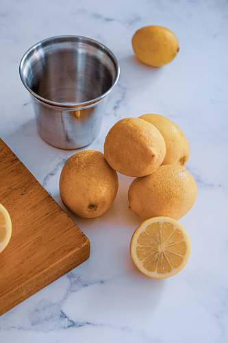 citrus fruit lemon fruits and gray stainless steel cup fruit